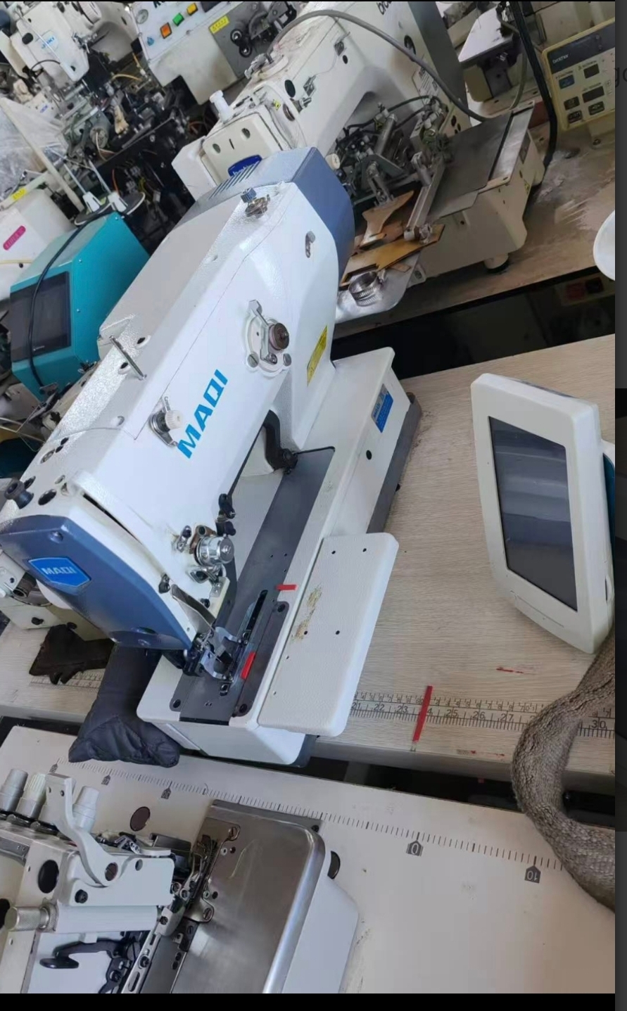Maqi electronic button hole machine for apparels.